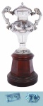 Troféu Taça Dr Gilberto Cardoso , em prata contrastada e base de madeira. Alt.total 50 cm. Peso aprox. 1.193 g