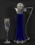 Lote contendo duas peças, sendo: 1 decanter em vidro azul e metal prateado ( 37 cm) e taça alça em cristal lavrado ( 23 cm).