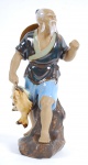 Estatueta em cerâmica vitrificada policromada, representando figura de pescador, medindo 23 x 9 cm.