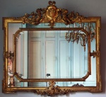 Imponente espelho francês ,bzotado e moldura dourada com alegoria de anjos , face feminina e elementos de música. Medidas 144 x 154 cm.