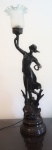 Luminária em pet bronze assinada, representando figura feminina (falta um pedaço na perna), cúpula em vidro leitoso, para uma lâmpada, altura total 87 cm. OBS: RETIRADA NO LOCAL AV ATLANTICA