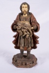 Imponente e rara imagem representando São José de botas, de madeira policromada com mãos e rosto em marfim. Século XVIII. Alt. 34 cm.