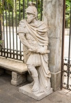 Escultura em pedra, representando " Soldado" , ao gosto da estatuária greco romana, marcas do tempo, medindo 195x60x70 cm