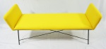 Martin Eisler, pequeno sofá, estrutura em ferro, estofado em tecido amarelo, medindo 60 x 132 x 41 cm.