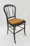 Cadeira chinesa em madeira laqueada e detalhes na cor ouro, assento em palhinha com almofada solta, encosto vazado, (falta uma trava). Medida 86 x 41 x 40 cm.