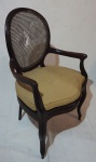 Cadeira de braço em madeira nobre, assento com estofado em tecido, medindo 105 x 63 x 56 cm. Palha natural danificada.