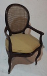 Cadeira de braço em madeira nobre, assento com estofado em tecido, medindo 105 x 63 x 56 cm. Palha natural danificada.