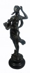 Escultura em bronze patinado, representando Figura Feminina  com cesto. Alt. 43 cm.