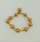 Pulseira em ouro amarelo, dita "jóia escrava", sem contraste, com dez esferas com 12 mm cada, peso total 14.4 g