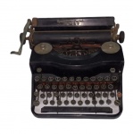 Antiga máquina de escrever da marca REMINGTON  PORTABLE, na cor preta (máquina necessita reparos).